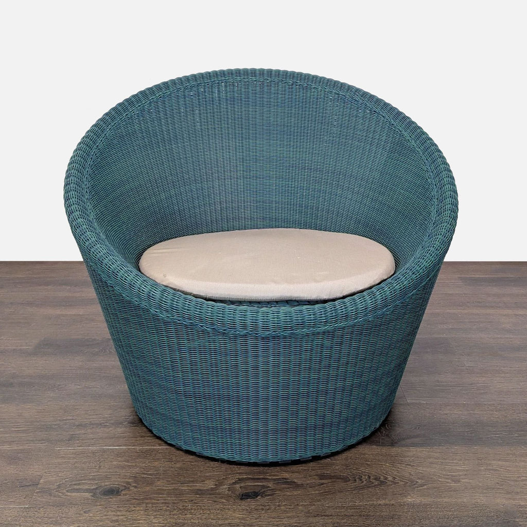 Pair of rounded blue lounge chairs by Crate and Barrel, featuring soft beige cushions and modern woven design.