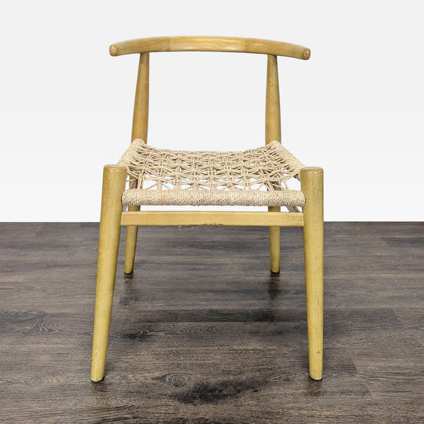 1. Wooden dining chair with curved backrest and woven rope seat, shown from the front on dark flooring.  