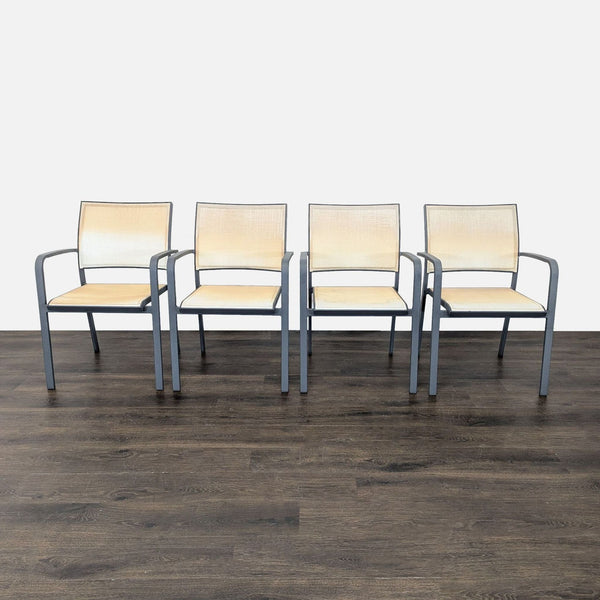 1. Set of four beige mesh chairs with metal frames and armrests, arranged in a row on a wood floor.  