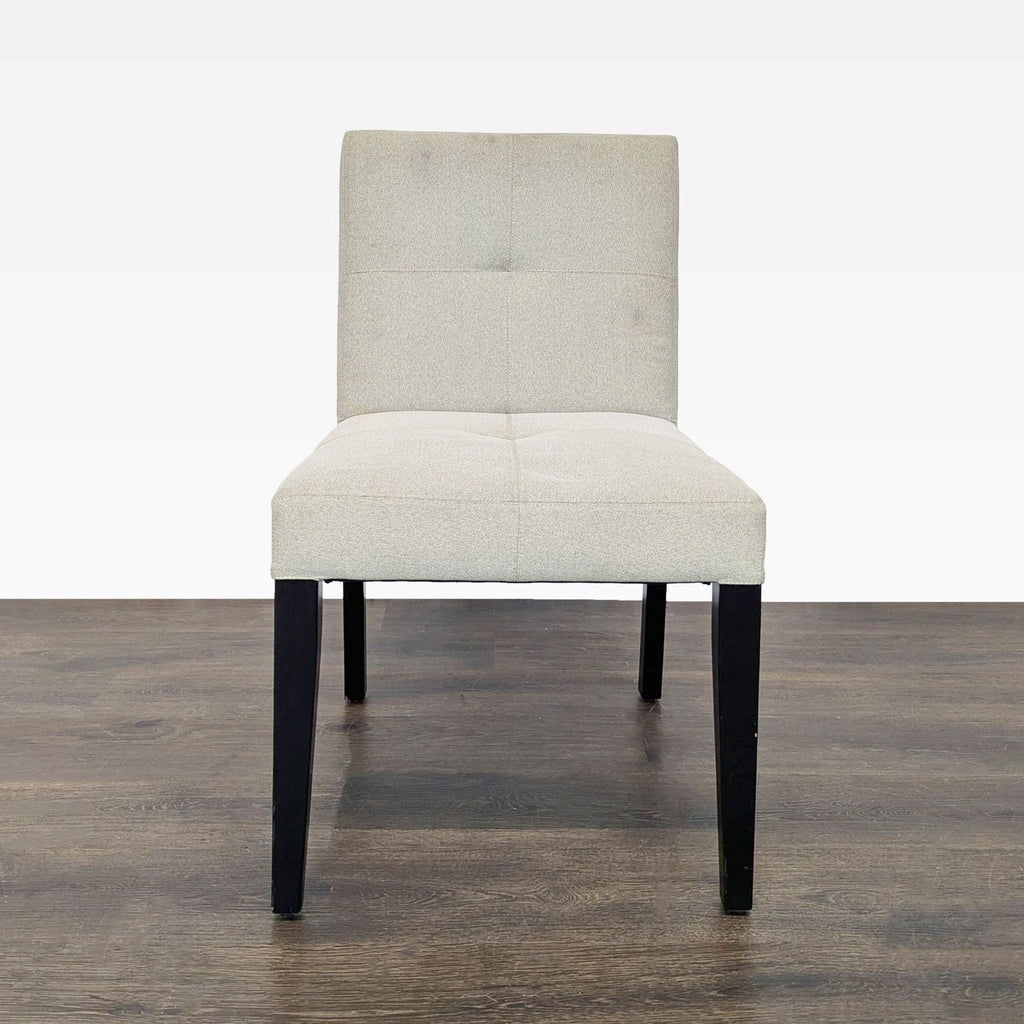 Set of Crate & Barrel low-back dining chairs featuring wood legs, ideal for contemporary dining rooms.