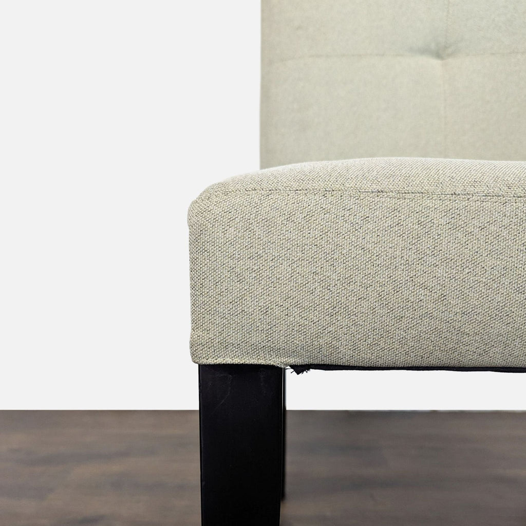 Crate & Barrel dining chairs with low backs and sturdy wood legs, suitable for stylish dining spaces.