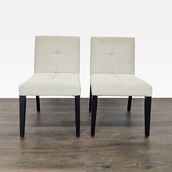 Low-back dining chairs with wooden legs, designed by Crate & Barrel, displayed in a modern setting.