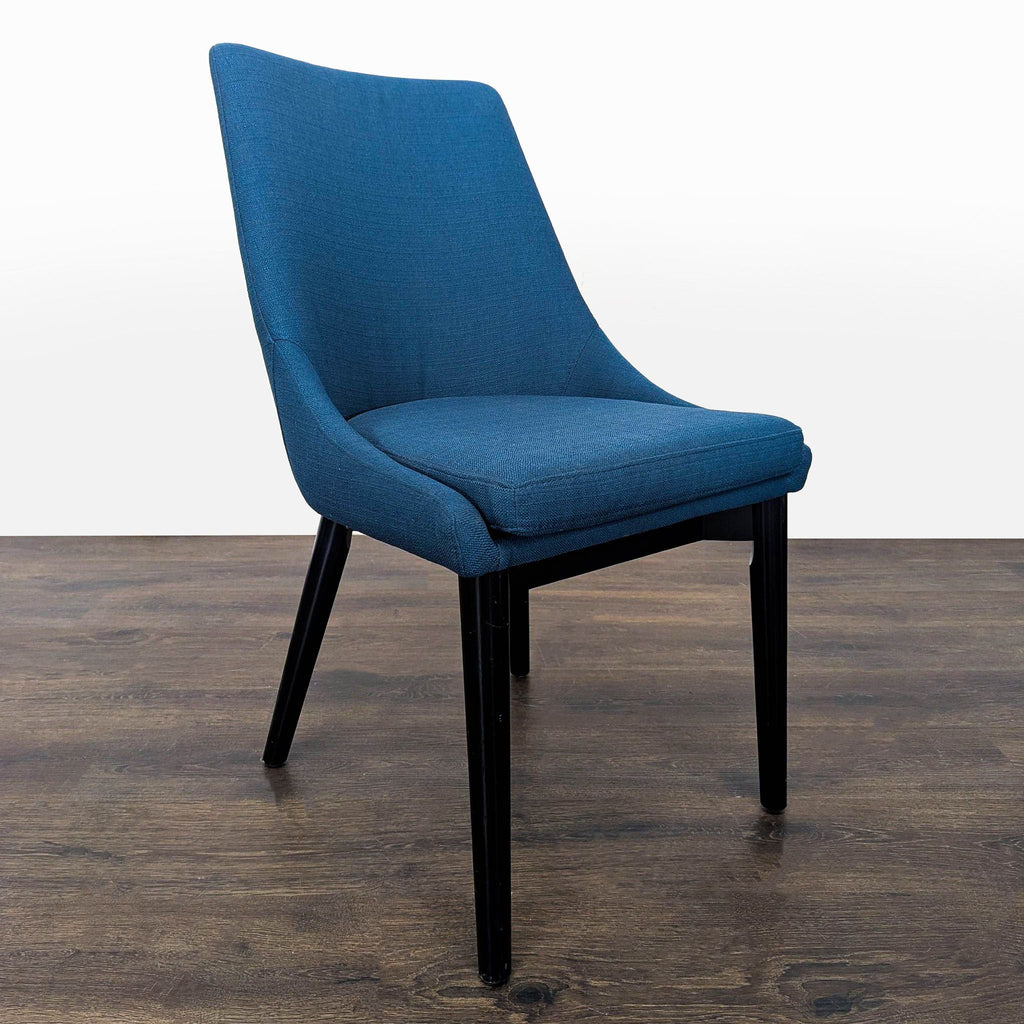 2. Angled view of a Modway modern blue dining chair, featuring sleek fabric upholstery and black legs.