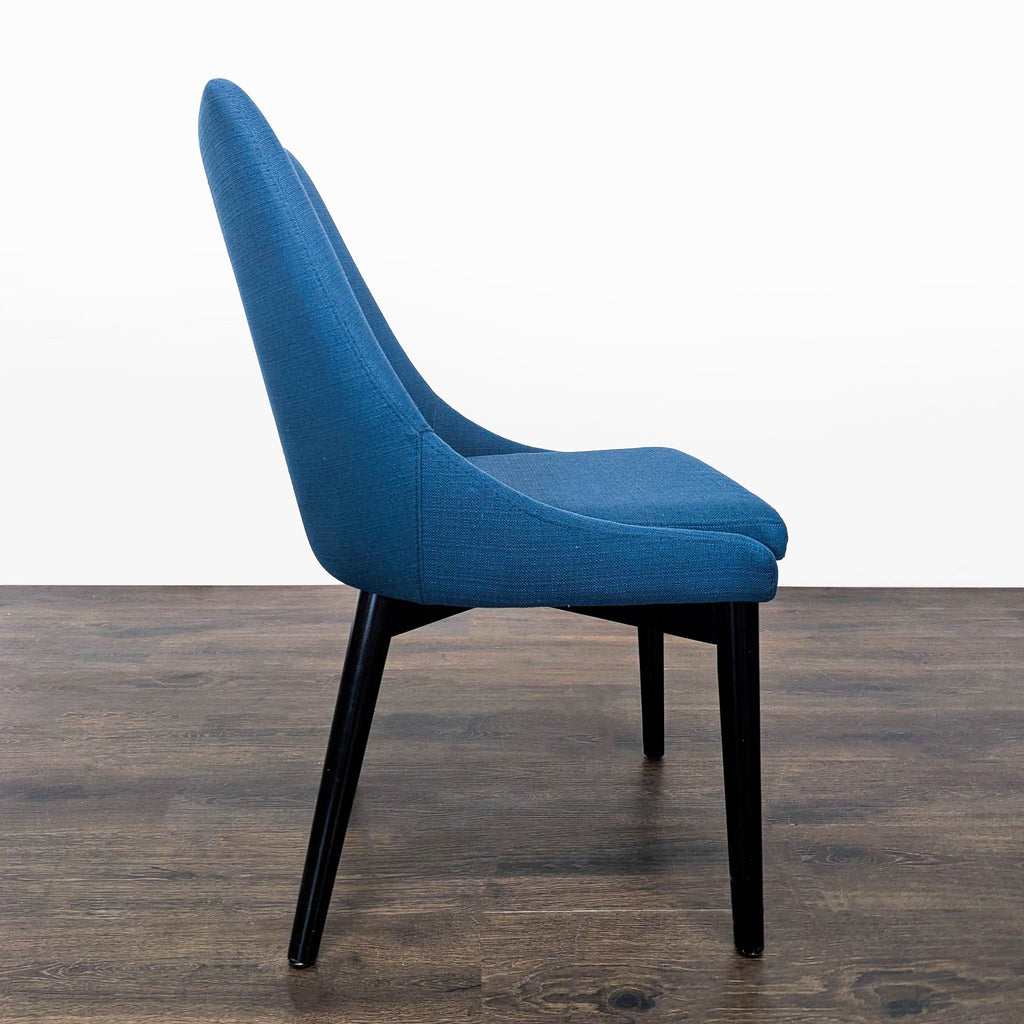 3. Side profile of a blue Modway dining chair, highlighting its curved backrest and contemporary design.