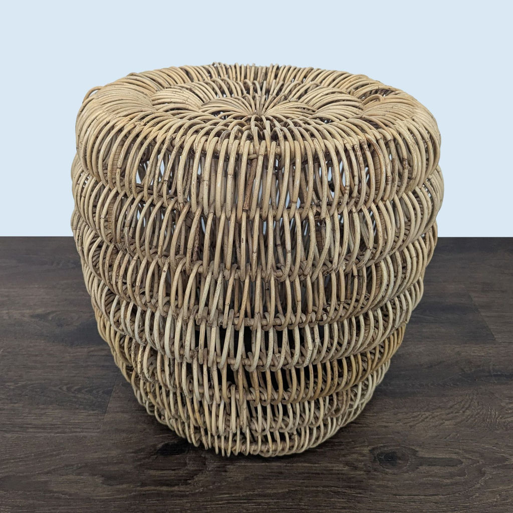 3. Top view of a woven rattan side table, highlighting its circular, airy design on a wooden floor.