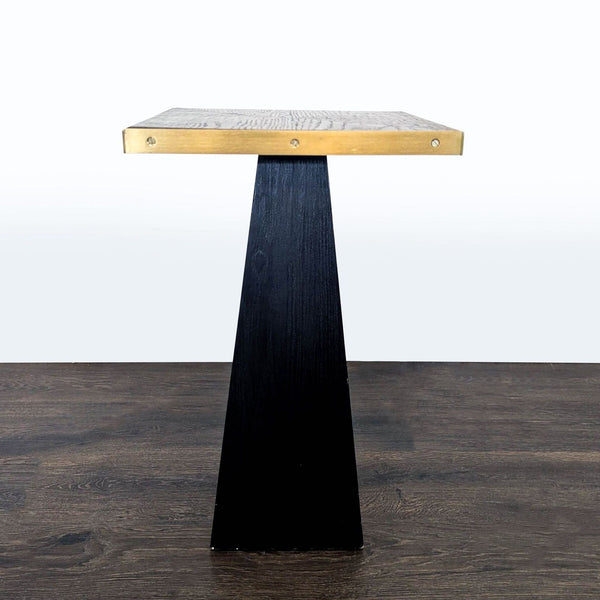 Round wood end table with metal trim around the top and base.