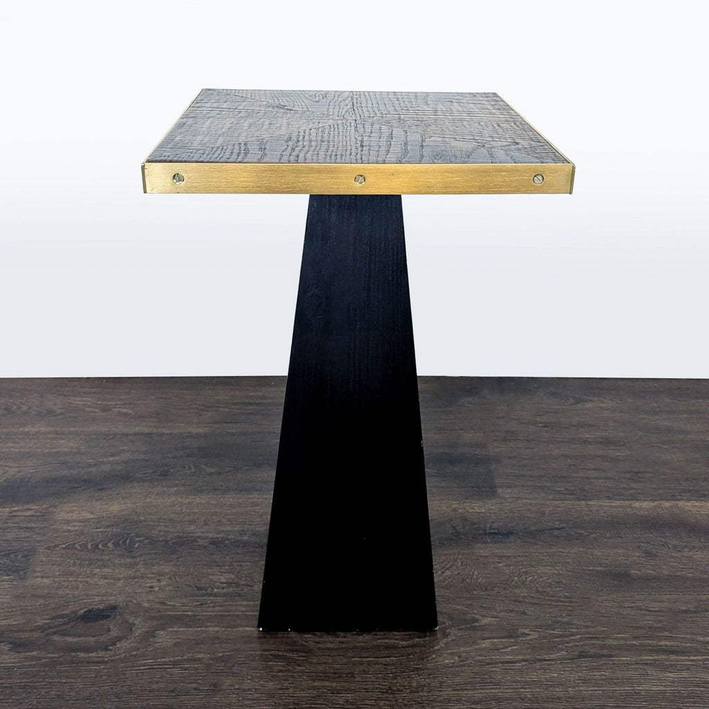 Small wooden pedestal end table featuring metallic trim accents.