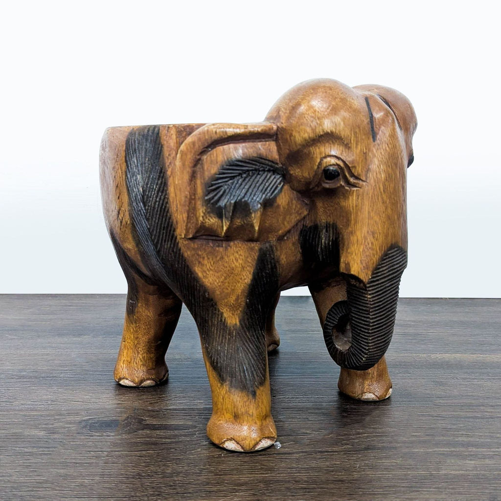 3. Angled view of a wooden bench in the form of an elephant, highlighting ear and trunk craftsmanship.