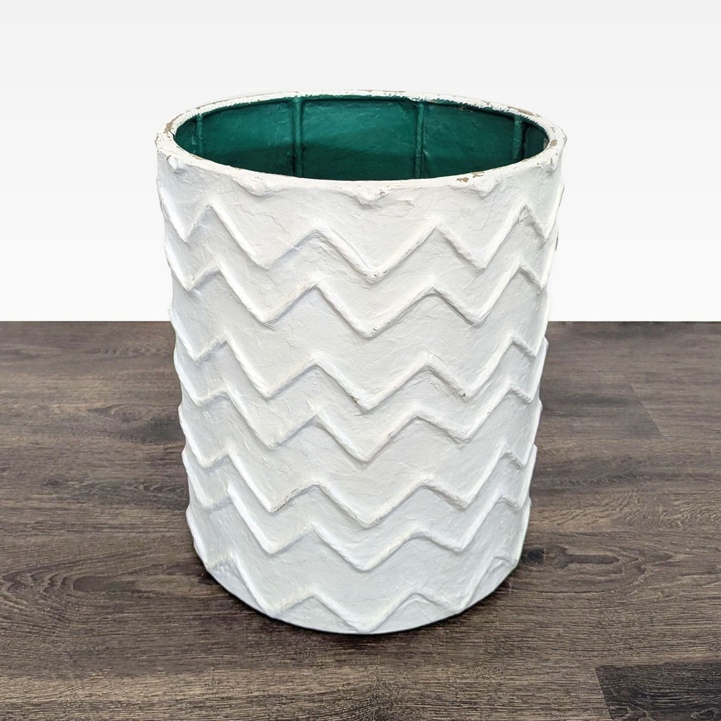 Modern vase featuring a distinctive plaster texture and cylindrical shape.  