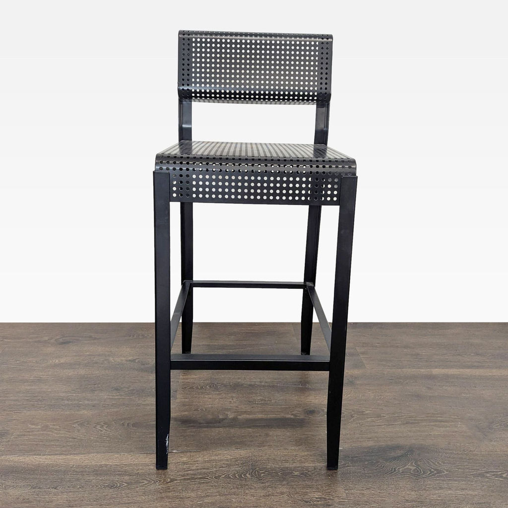 2. Single Ikea bar stool with perforated black metal seat and backrest, shown from the front on wood floor.