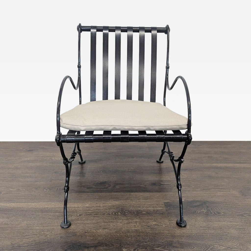 Project 62 lounge chair with black slatted metal frame, curved arms, and beige seat cushion for comfort.
