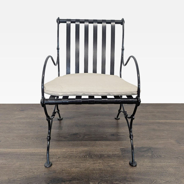 Project 62 lounge chair with black slatted metal frame, curved arms, and beige seat cushion for comfort.