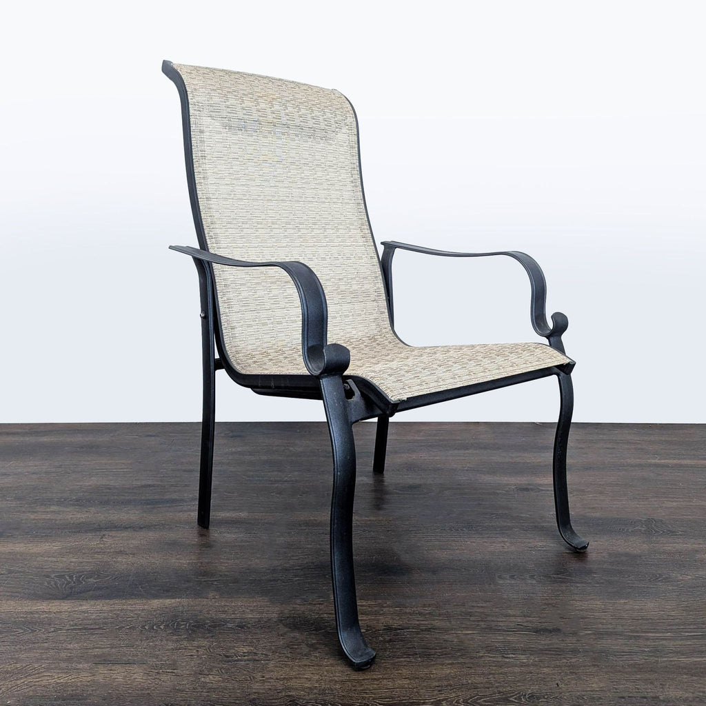 Two beige mesh outdoor chairs with curved armrests and sturdy black frames, designed for patios or gardens.