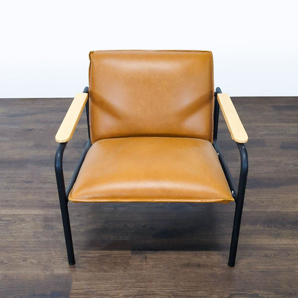 Modern lounge chair with brown faux leather cushions, black metal frame, and wood armrests.  