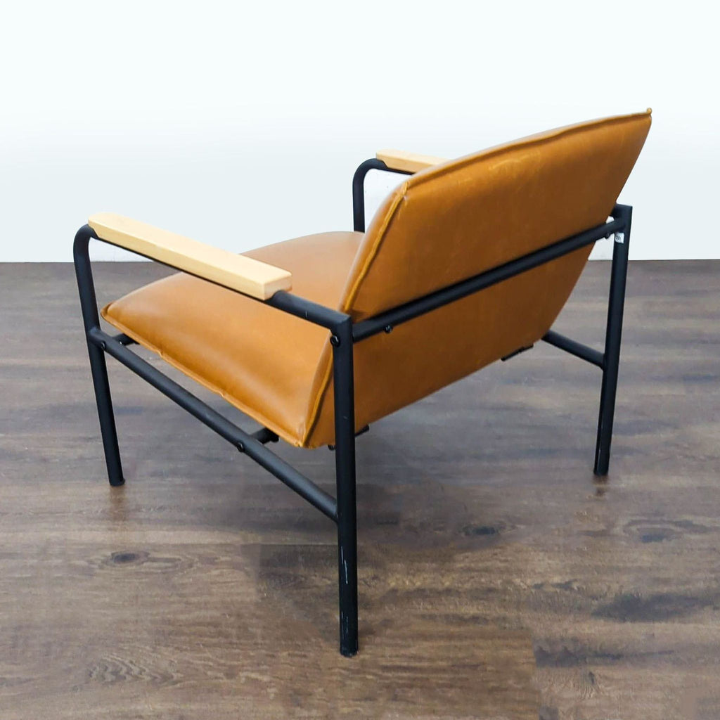 Contemporary lounge chair with brown faux leather, black metal structure, and comfortable wood armrests.