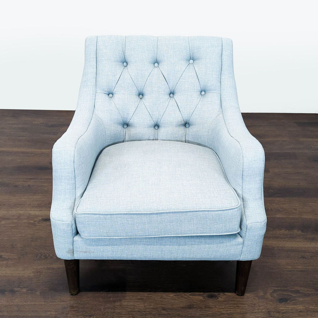Light blue Madison Park lounge chair with tufted backrest, curved armrests, and dark wooden legs.