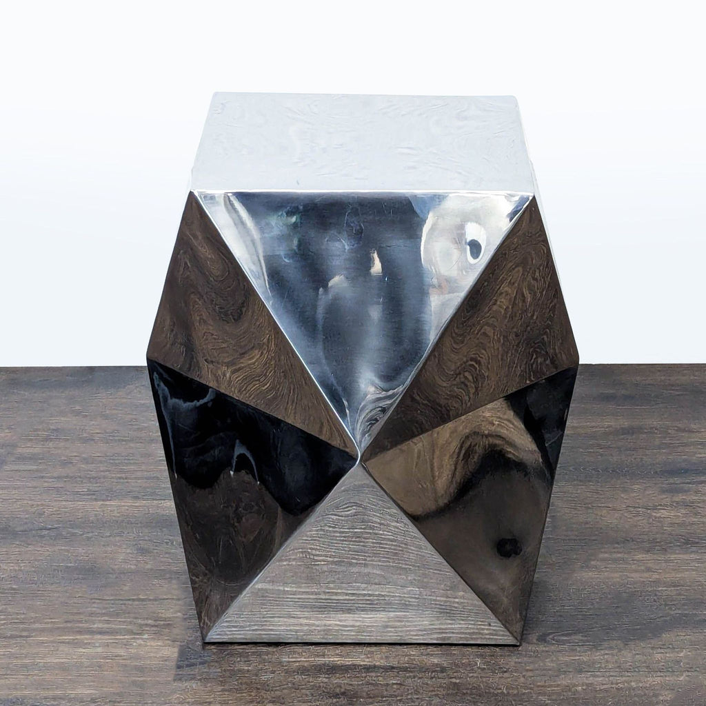 2. Modern metallic console table featuring an angular, sculptural design with mirrored triangular panels.
