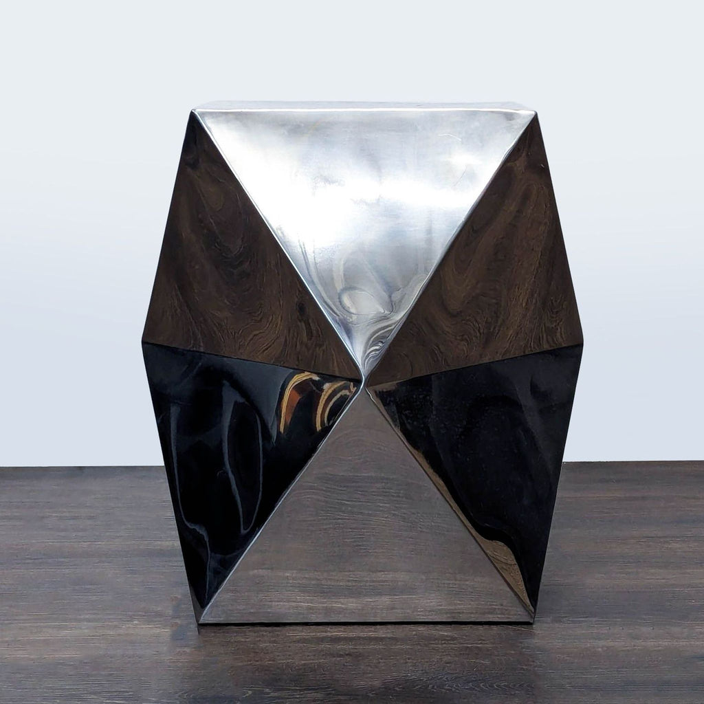 3. Faceted chrome-finished side table with a unique geometric shape, ideal for contemporary interiors.