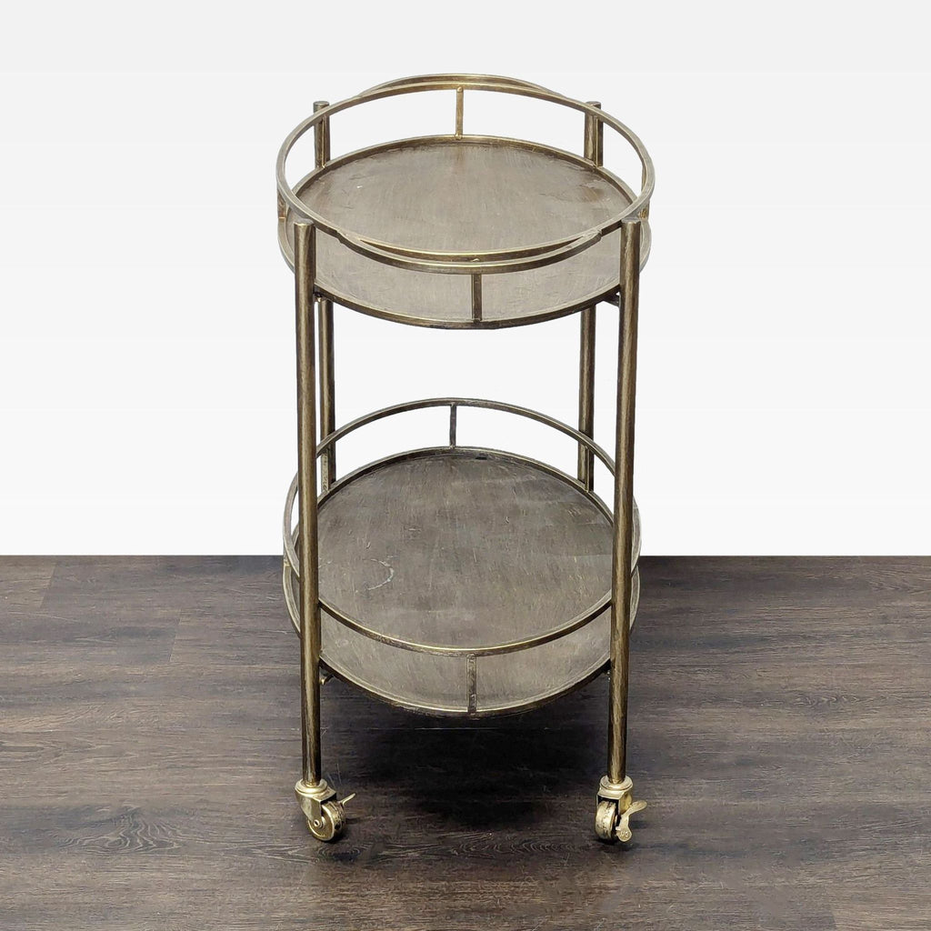 3. Side view of a gold-finished bar cart with dual trays and caster wheels for easy movement.