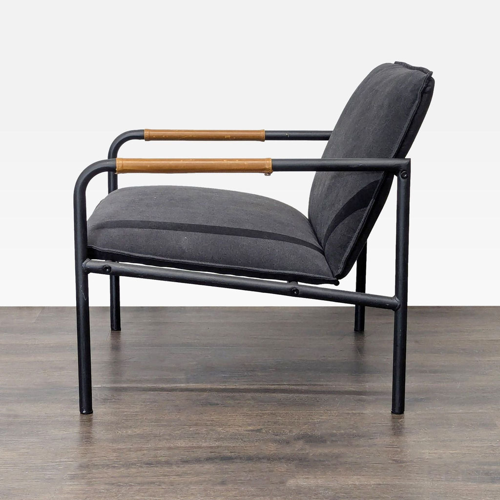 Modern Sauder lounge chair with sleek black upholstery and wooden-accented armrests, perfect for lounges.