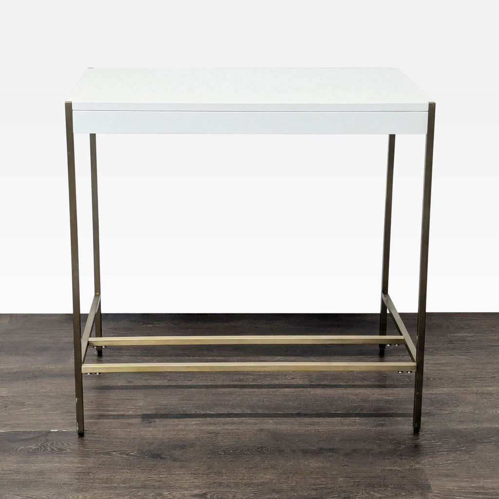 Minimalist West Elm desk, white surface and brass structure, perfect for home office or apartment use.