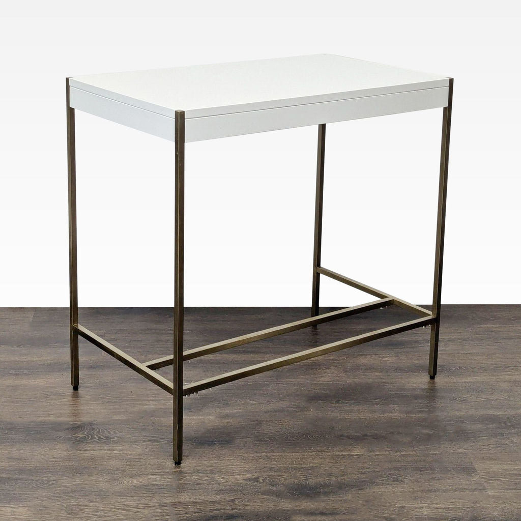 Modern West Elm writing desk featuring a sleek white tabletop and sturdy brass metal legs.