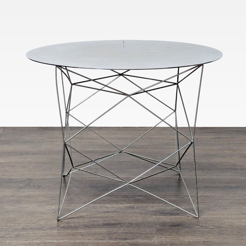 1. Modern West Elm end table with a round marble top and geometric wire metal base on dark wood flooring.