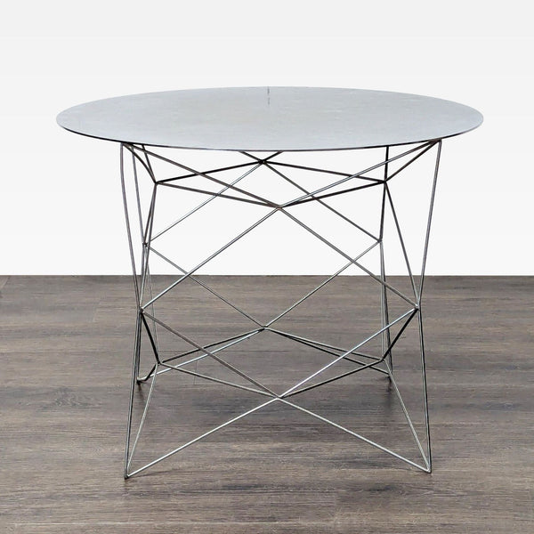 1. Modern West Elm end table with a round marble top and geometric wire metal base on dark wood flooring.