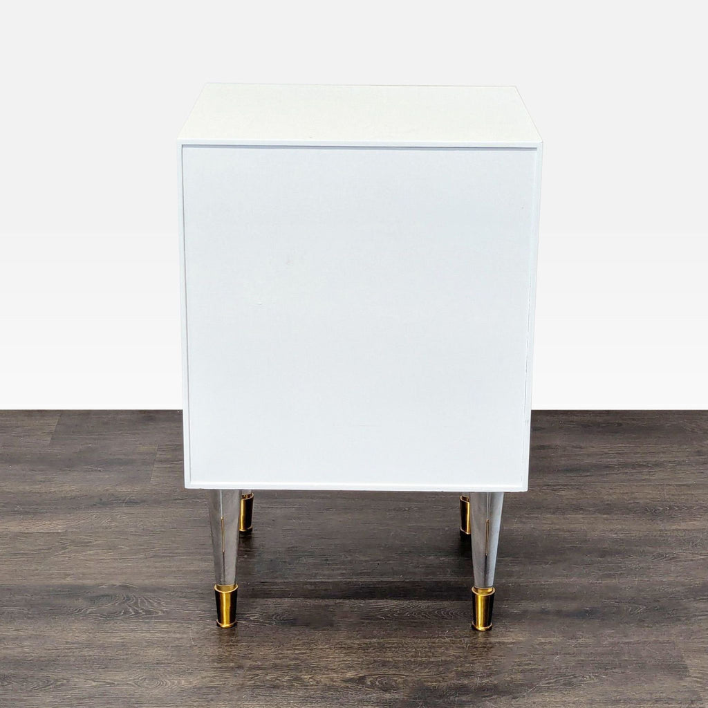 3. Back view of a white end table with lucite and brass legs, no visible hardware or detailing.