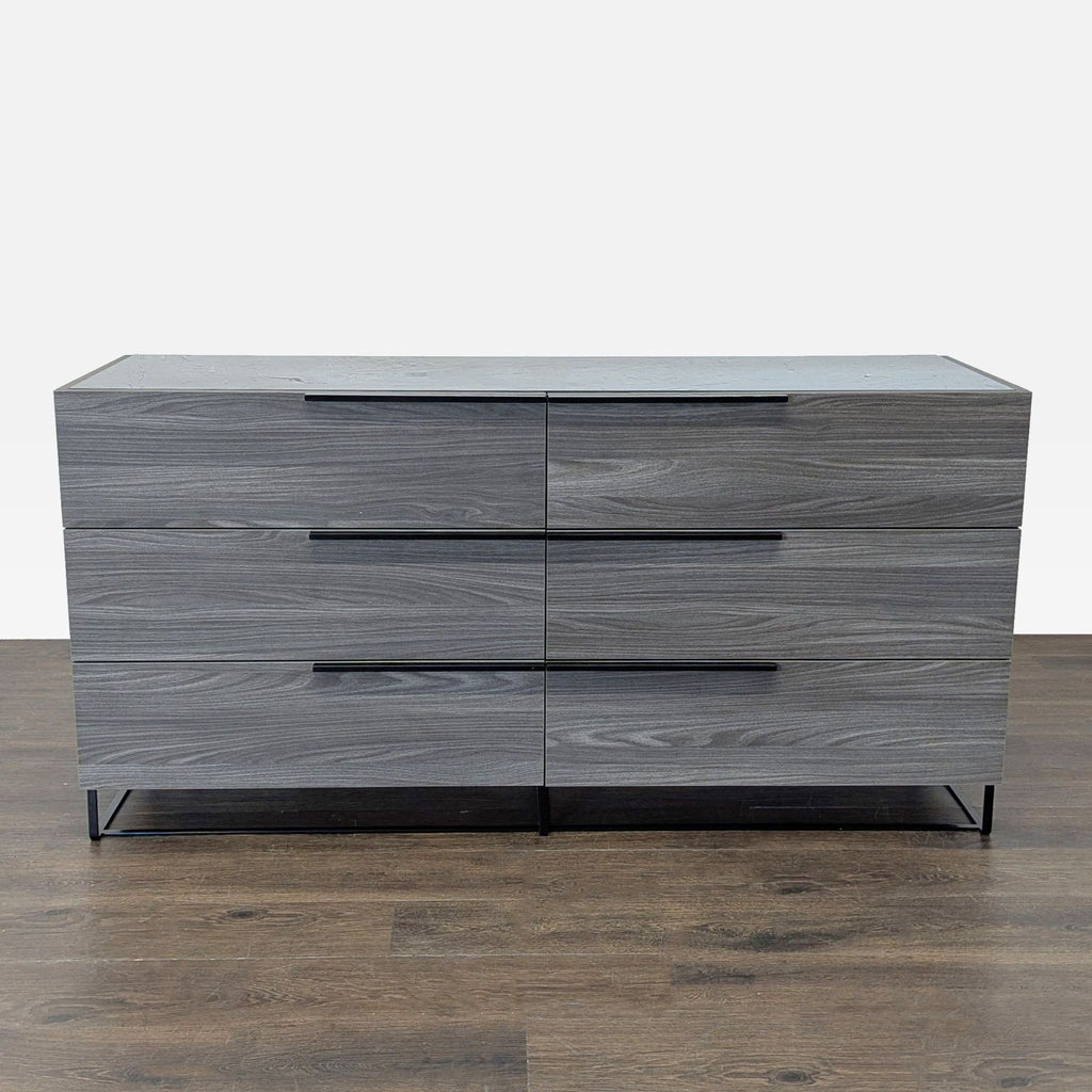 Sleek Modrest dresser in gray wood with black metal legs and six spacious drawers, perfect for modern bedrooms.