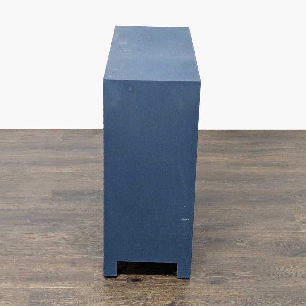 3. Side profile of Bungalow Rose navy linen cabinet, highlighting its simple rectangular shape and flat surface.