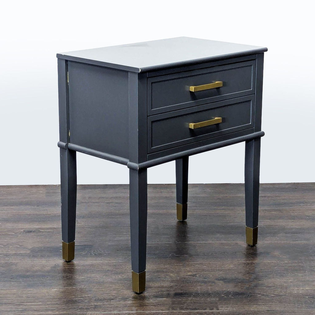 3. Modern gray end table by CosmoLiving by Cosmopolitan, featuring gold drawer handles and leg caps.