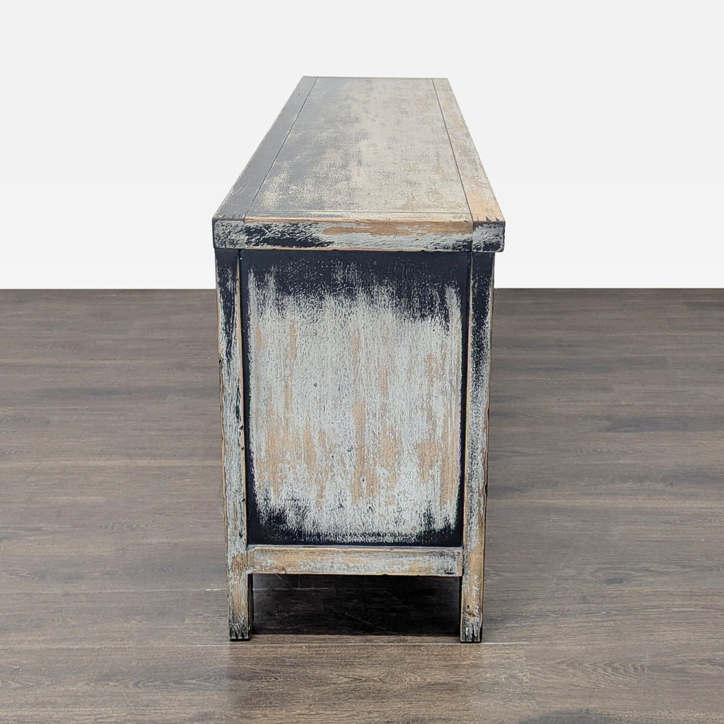 Four Hands media console in distressed black with copper-clad hardware, antique European flair.