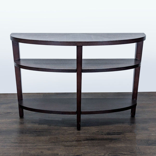 1. Dark wood three-tier half-moon console table with open shelves, shown from the front on a wood floor.  