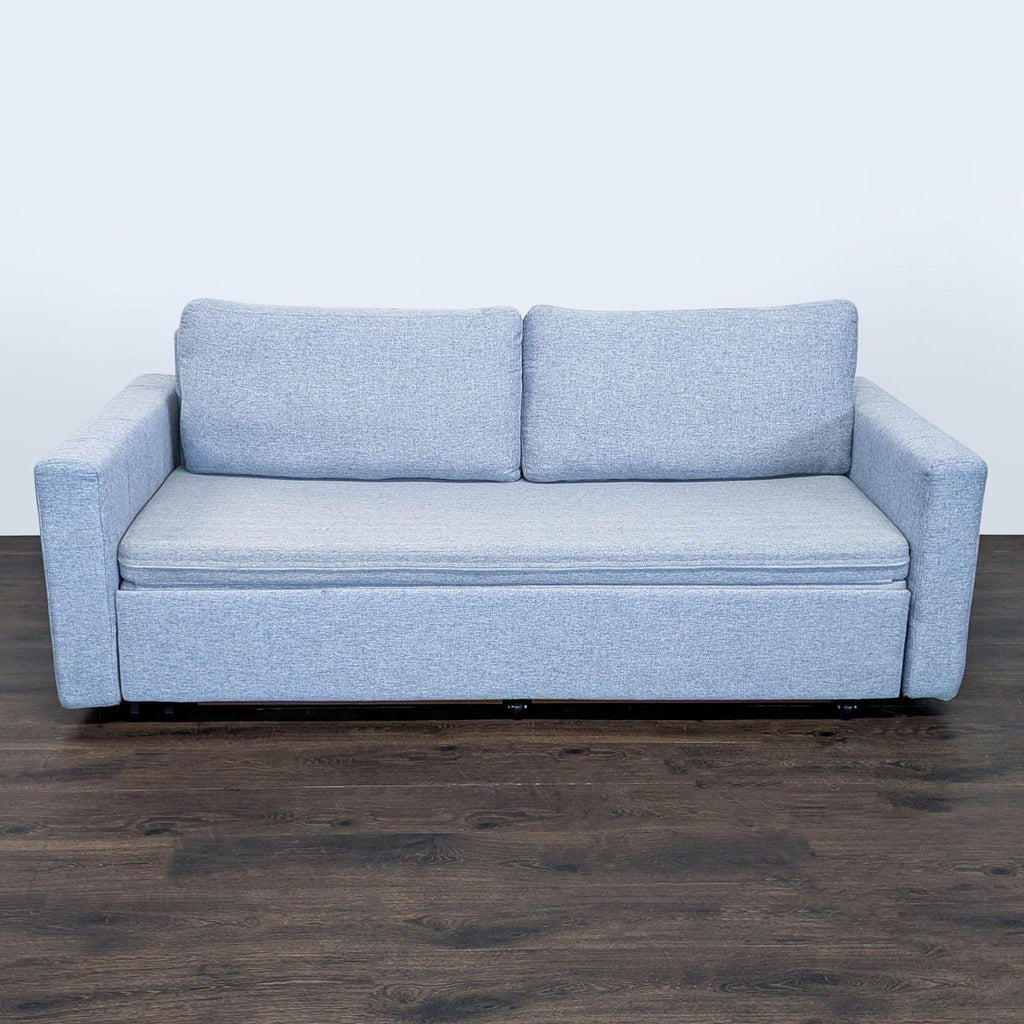 Modern light gray sleeper sofa with sturdy arms, easily converting into a spacious bed for guests or small spaces.  