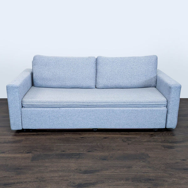 Modern light gray sleeper sofa with sturdy arms, easily converting into a spacious bed for guests or small spaces.  