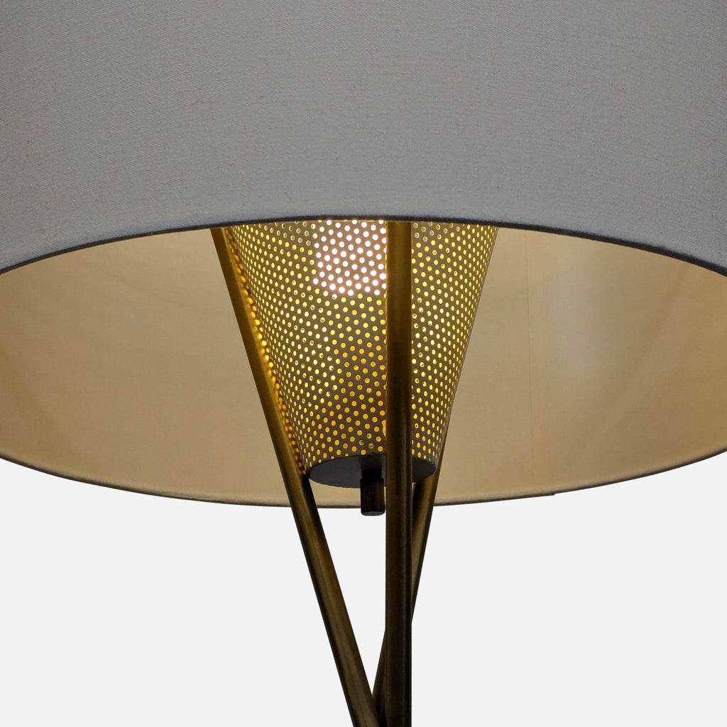 Modern brass floor lamp featuring a white shade and inner diffuser for a soft, warm light in any space.  