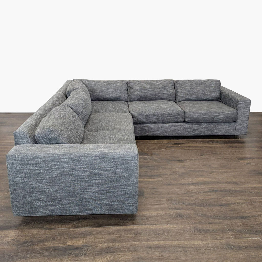 Modern gray West Elm sectional with clean lines, plush cushions, and spacious seating for living rooms.