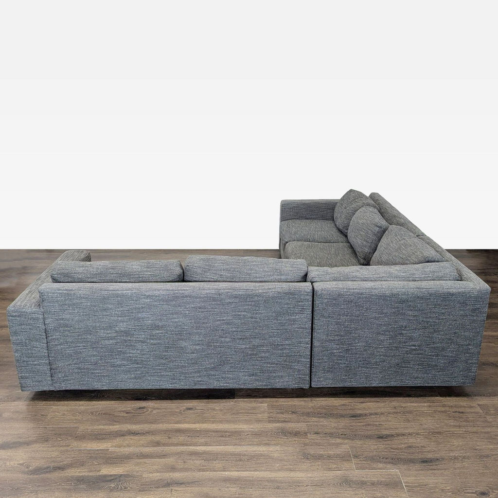 Contemporary West Elm sectional couch in gray fabric with ample seating, ideal for large living spaces.