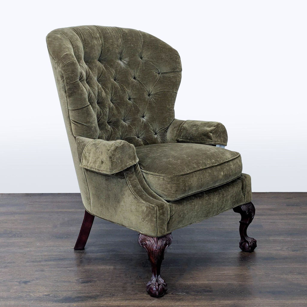 Classic lounge chair by Thomasville featuring plush olive fabric, tufted back, and ornate wooden claw feet.  