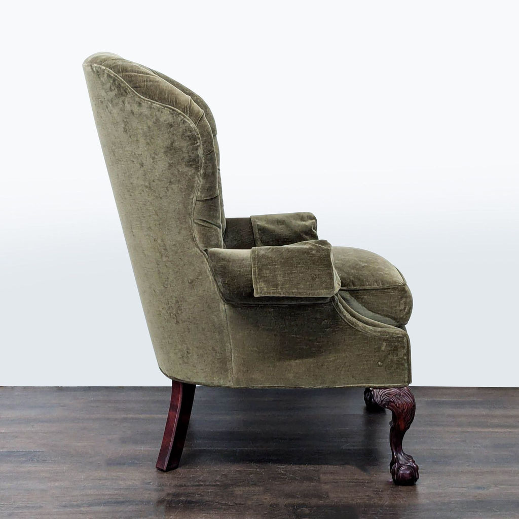 Olive green Thomasville lounge chair with tufted backrest and detailed carved wood legs for a stylish touch.