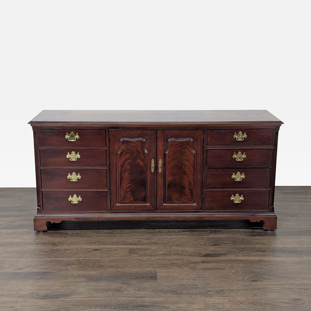 1. Thomasville dresser with a dark wood finish, nine drawers, brass hardware, and central cabinet doors.  