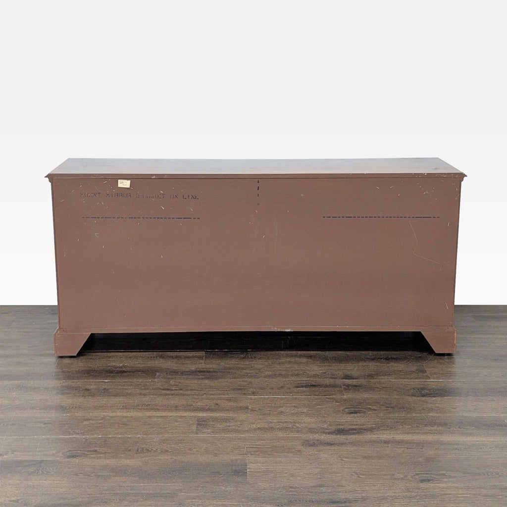 3. Rear view of a large Thomasville dresser, displaying a plain wooden back panel with minor wear.