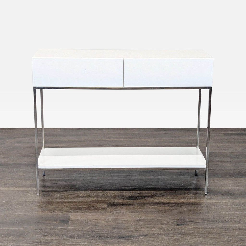 1. White West Elm console table with two drawers, slim chrome frame, and minimalist design, viewed from the front.  