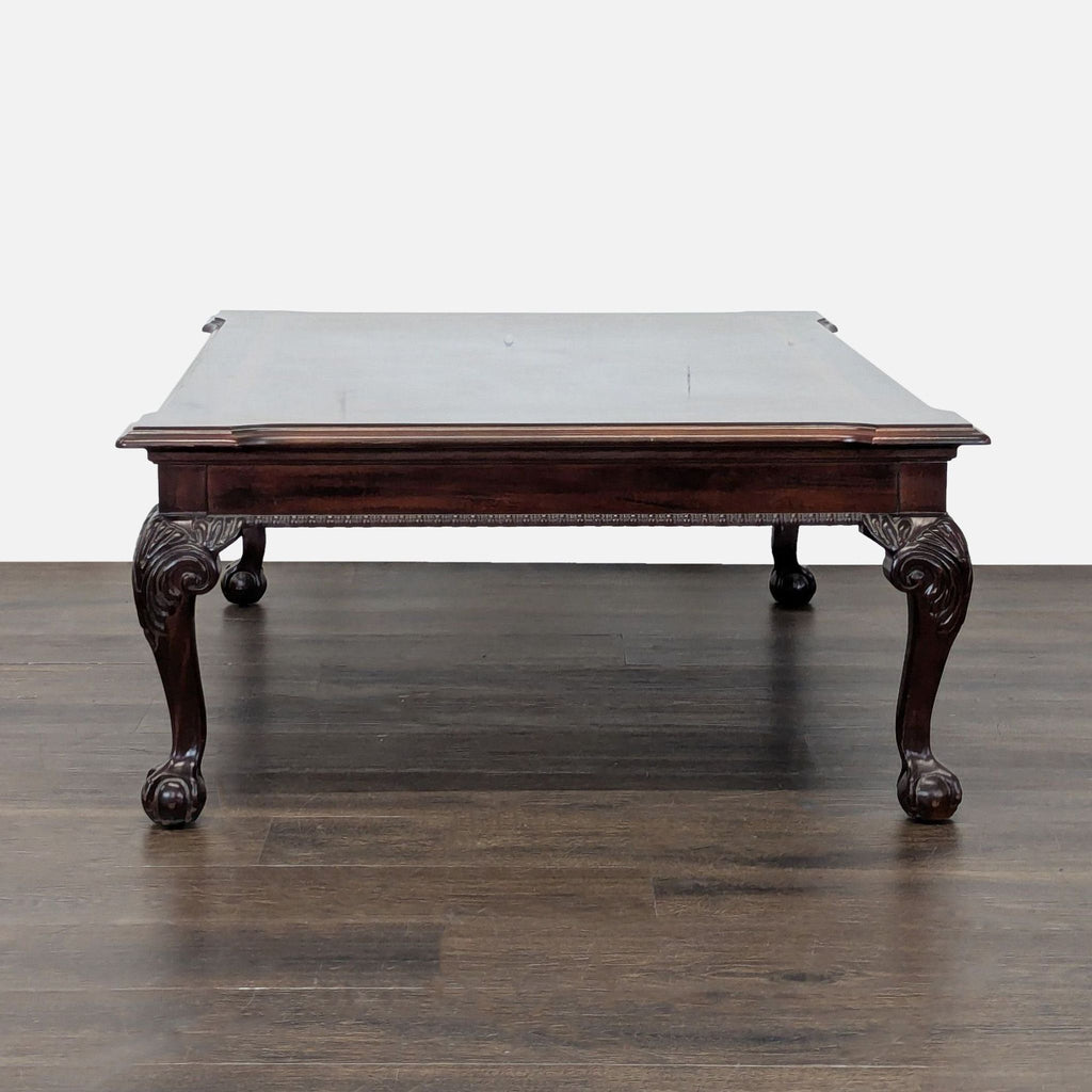 2. Vintage mahogany coffee table featuring a book-matched veneer top, gadrooned apron, and cabriole legs.  