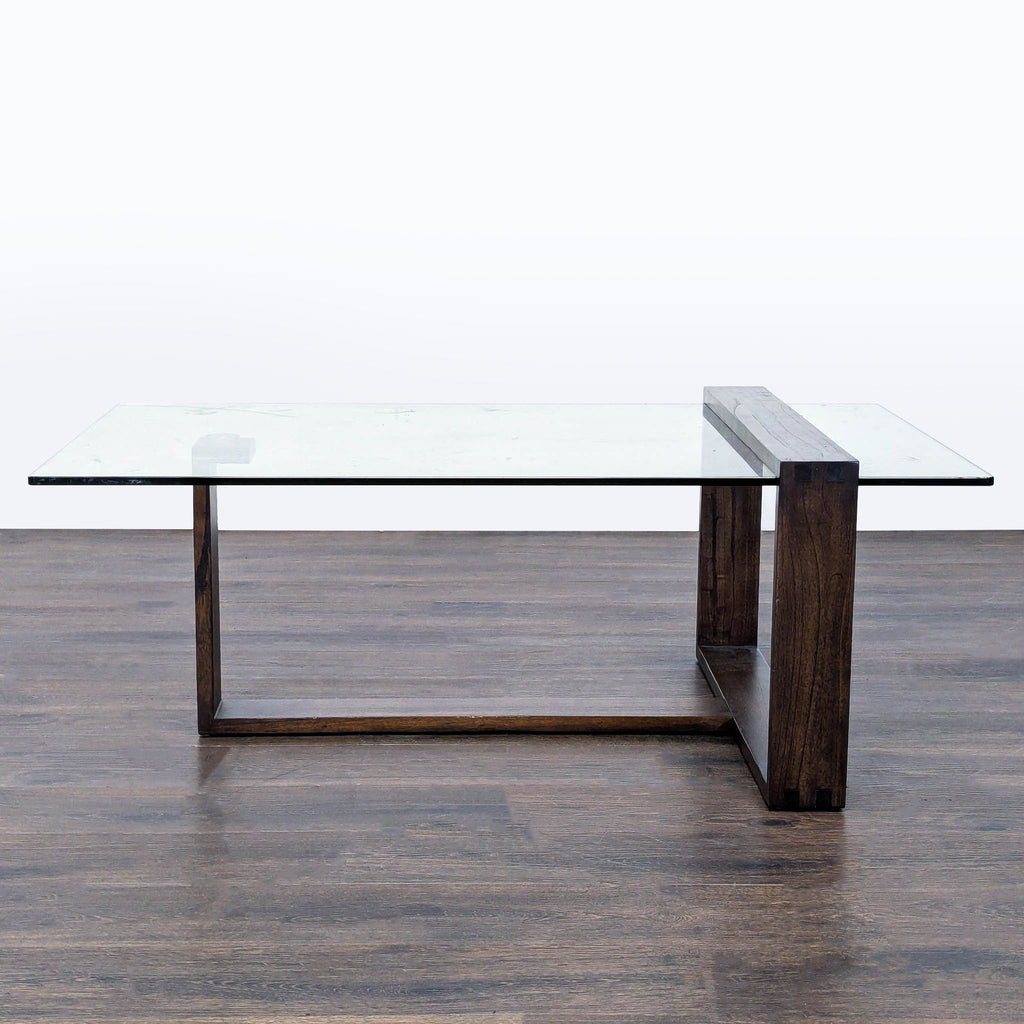 2. Mid-century modern coffee table by Living Spaces featuring a rectangular glass top and wood frame.