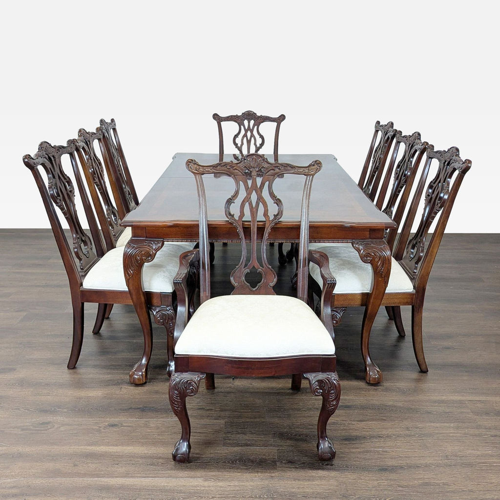 Elegant dining set featuring a spacious mahogany table and eight matching chairs with light upholstered seats.