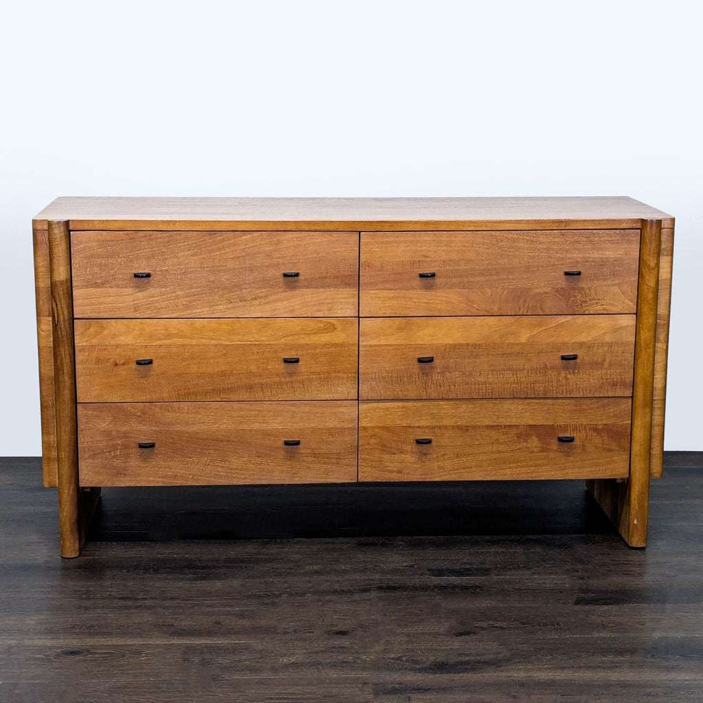 West Elm solid wood dresser with six drawers, natural finish, and subtle metal handles for modern bedroom storage.  