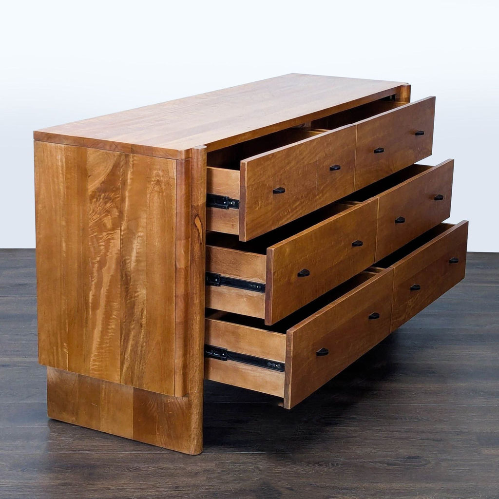 Contemporary West Elm dresser in natural wood, featuring six spacious drawers and minimalist metal handles.  