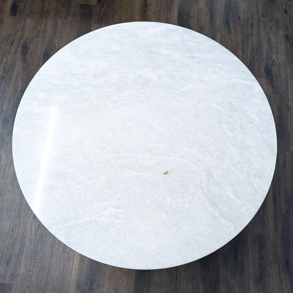 Dining table with a sleek metal pedestal base, from Anthropologie.  